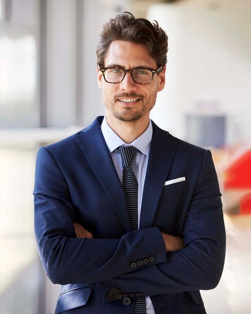 Portrait of young professional man in suit arms c PX3MUP4.jpg