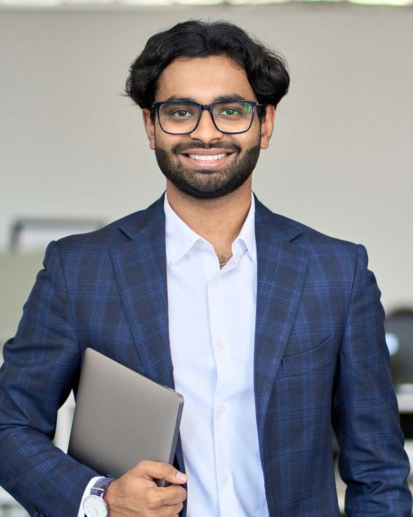 Smiling young indian business man wearing suit sta BFCJEWE.jpg